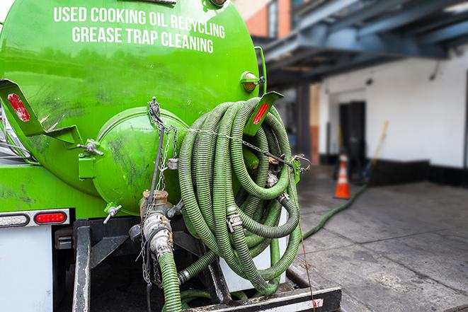 a service truck pumping grease from a restaurant's grease trap in Centereach